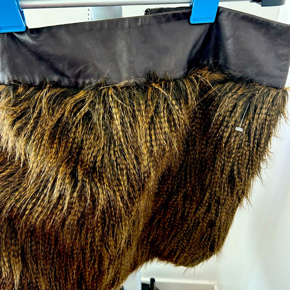 Mini skirt is a combination of leather and feathers really fun